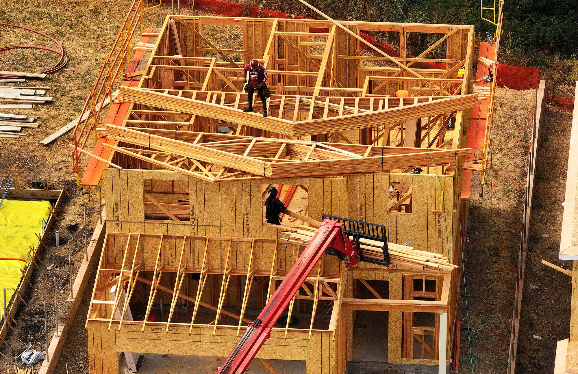 Construction workers build a home at a new housing development on July 1
