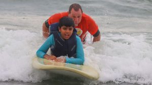 Volunteers Help Kids With Disabilities Surf