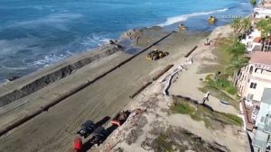 Long Beach Crews Build Sand Berms As Potentially Record High Tides Threaten Peni