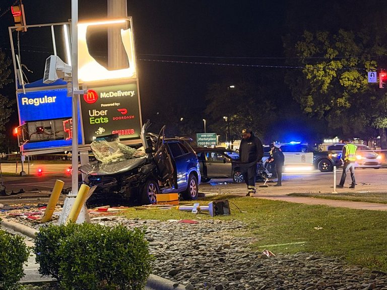 Van Crashes Into Gas Station Sign After Red Light Collision On Capital Boulevard
